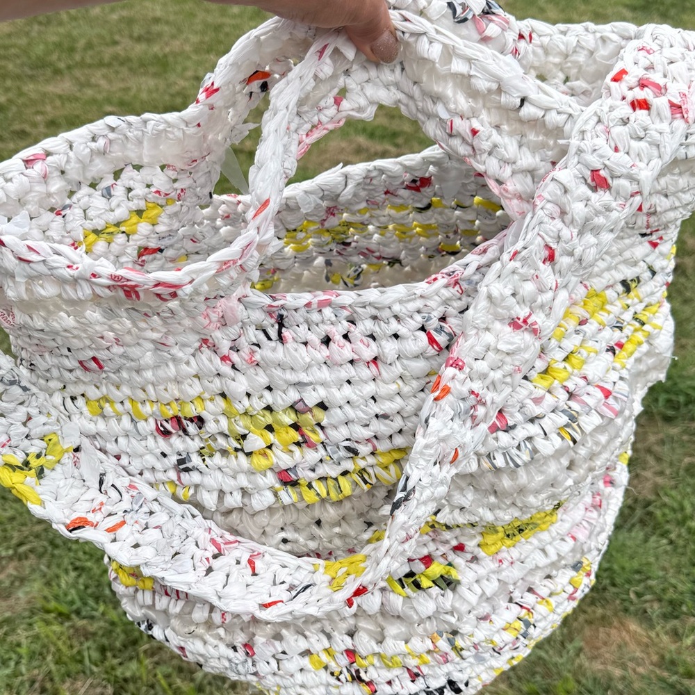 Handmade from plastic bags crocheted shopping tote bag with a pocket